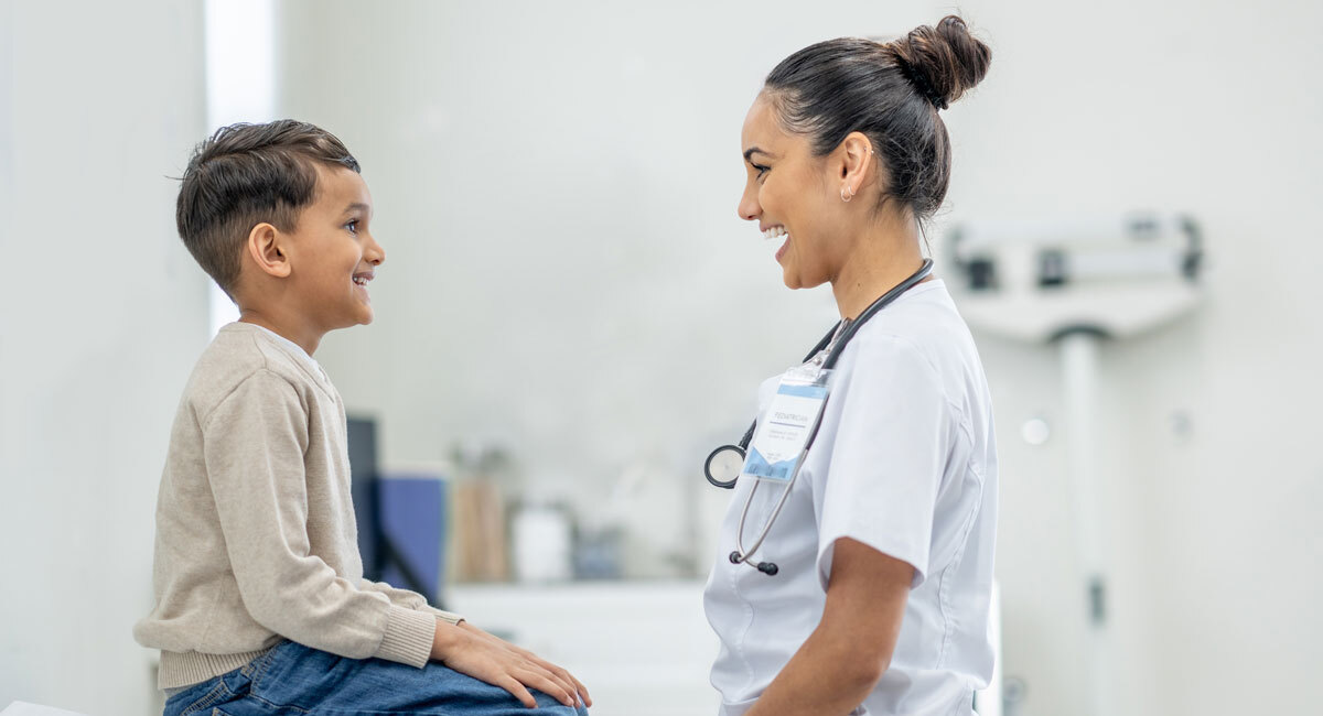 Physician listening to child's heartbeat